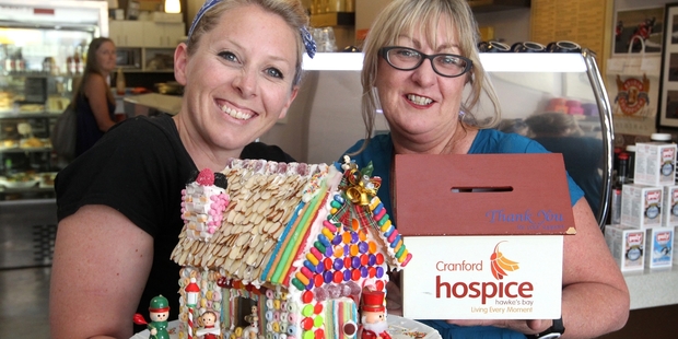 HAPPY HOUSE: Kerryn Taylor (left) and Alison McKee show off the fundraising gingerbread house. PHOTO/DUNCAN BROWN