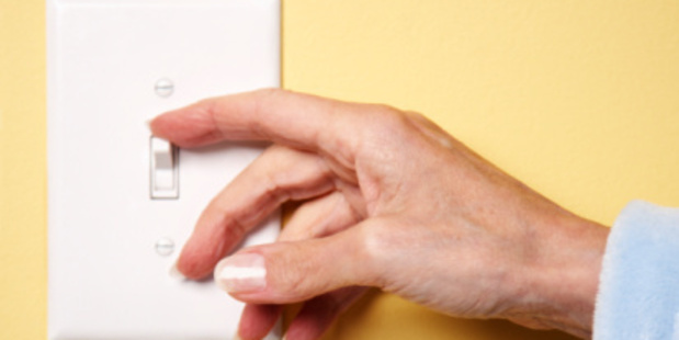 Woman Turning Lights Off