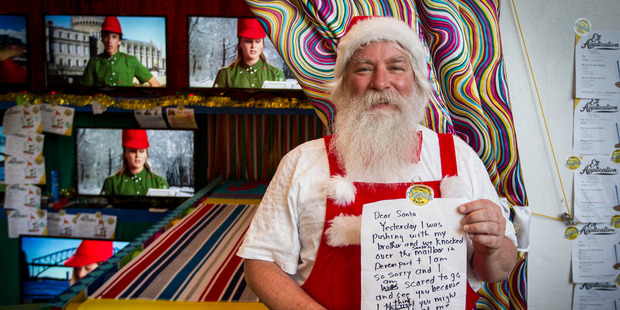 Santa's Bach was the scene of mirth when Father Christmas received a note about a damaged letterbox. Photo / Michael Craig