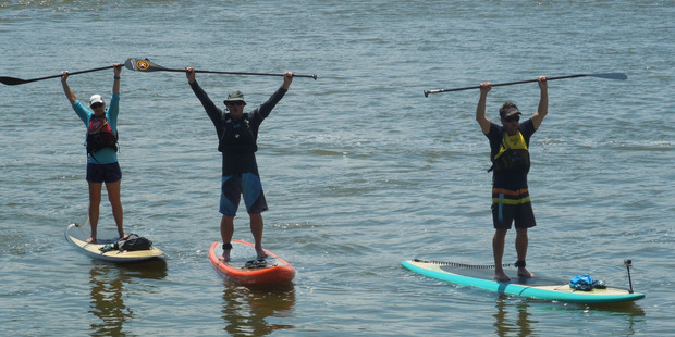 Kirsten Wilton, Ross Parker and Brent Bourgeois, of Tauranga, exhausted after
paddling 350km on the Waikato River.