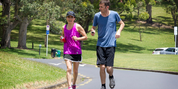 APNZ reporter Lane Nichols runs a few laps with Kim Allan who is running for 85 hours straight, around the Auckland Domain. Photo / Christine Cornege