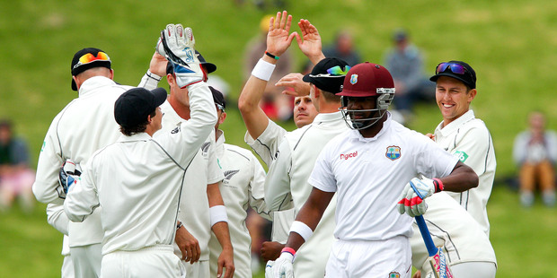 New Zealand players celebrate as lefthander Darren Bravo of the West Indies leaves the field after being dismissed. Photo / Getty Images