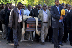Nelson Mandela's grandson Mandla Mandela leads local chiefs as they escort the lion skin draped casket of the former South African President as it arrives at the Mandela residence. Photo / AP