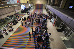 Passengers lineup in front of the Air France desk after their flight to Paris was finally called, following a delay due to terrorism fears. Photo / AP