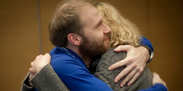 Photographer Denis Sinyakov of Russia and Greenpeace activist Sini Saarela of Finland embrace each other after hearing about the amnesty bill. Photo / AP