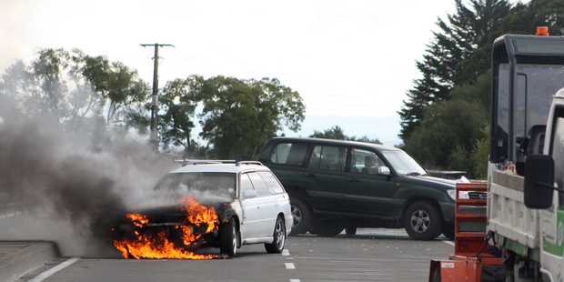 A car caught fire following a crash on Black Bridge near Haumoana yesterday. Photo/Brenda Morrell.