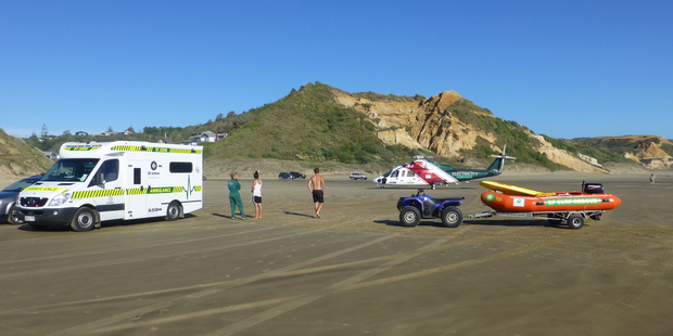 Rescuers at Baylys Beach where a 23-year-old woman who stuck trouble in the surf had to be evacuated to hospital. Photo/Northland Emergency Services Trust.