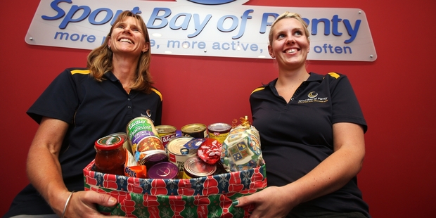 Jen Riley and Holly Cutbush of Sport Bay of Plenty with their donation to the Tauranga Foodbank. Photo / Joel Ford