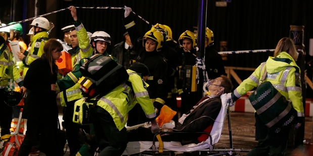 A man is wheeled away after the Apollo Theatre ceiling collapse. Photo / AP