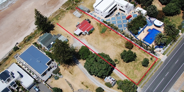 The tiny two-bedroom waterfront bach at Wainui Beach in Gisborne is surrounded by million-dollar mansions and is on the market for the first time in 60 years.