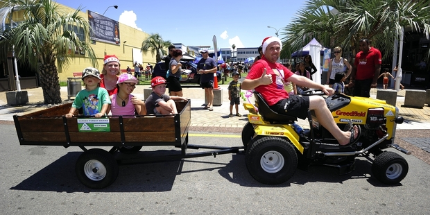 The Phoenix owners Mel and Mark Lawrence took Gianni Martin, 5 (red hat), Atareta Christie, 8, and Tamatea Christie, 2, for a spin on a ride-on mower.Photo/George Novak