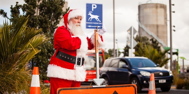 Santa Claus waits at a reindeer comfort stop.