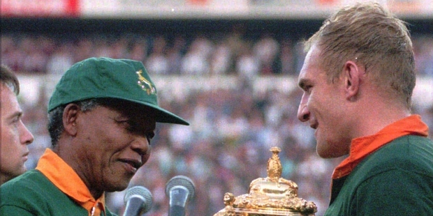 Bonding a nation, Springbok skipper Francois Pienaar receives the Rugby World Cup trophy from President Nelson Mandela. Photo / AP