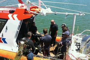 Police divers at the Whakatane River about to start the search.