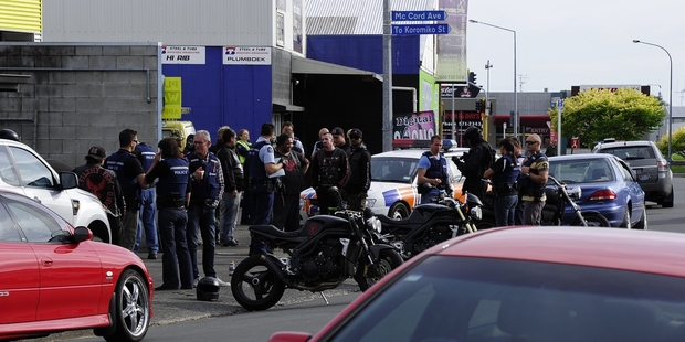 CHRISTMAS EVE DRAMA: Armed offenders squad members and other police outside the Filthy Few Motorcycle Club headquarters in Birch Avenue on Tuesday.