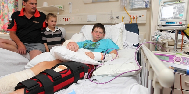 BROKEN: A bed-ridden Brayden Bullivant with his dad Tony and brother Caniel.PHOTO/DUNCAN BROWN HBT133063-05