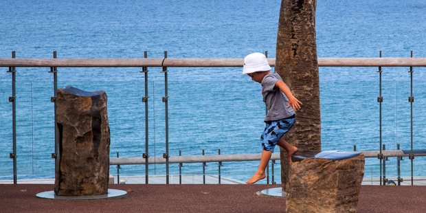 A child plays on Chris Bailey's 'Te Wai Puna o Rona' stone sculpture. Photo / Bob Scott