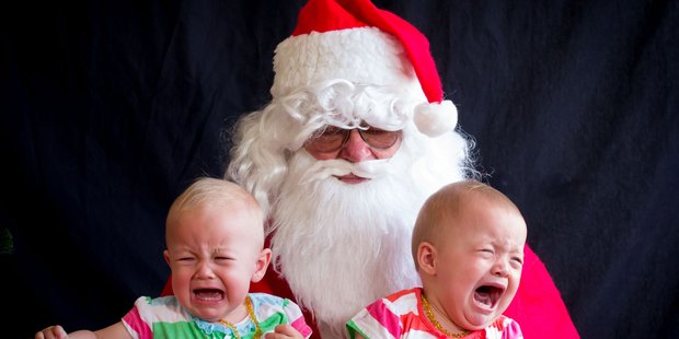 Don't worry girls, Christmas is nearly done with! Thirteen-month-old twins Eleanor, left, and Emily Williams not enjoying their time with Santa.