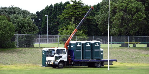 Contractors get to work after donated portable toilets were toppled in a vandalism spree at Blake Park.