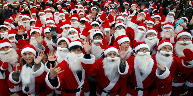 Some 1,000 volunteers clad in Santa Claus costumes gather to deliver gifts for the poor in downtown Seoul, South Korea.
