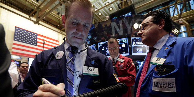 Michael Smyth, left, works with fellow traders on the floor of the New York Stock Exchange, Wednesday, Dec. 18, 2013. Photo / AP