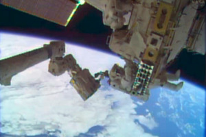 Astronauts Rick Mastracchio, top, and Michael Hopkins work to repair an external cooling line on the International Space Station. Photo / AP/NASA)