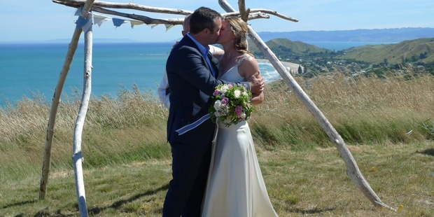 Matt Cairns gets hooked by new wife Joy after rescuing man in surf who was caught on a fishing line. Photo / supplied