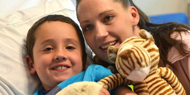 Sam Stainer, with mother Sandra, recovers in the children's ward at Dunedin Hospital after having major brain surgery. Photo / Peter McIntosh