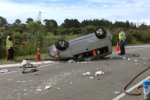 It took 30 minutes for a fire crew to cut free the trapped driver of the overturned van. Photo / 3 News