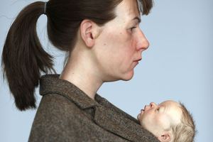 This sculpture is titled 'Woman with shopping' and shows a mother carrying two shopping bags with a newborn baby swaddled in her coat. Photo / Getty Images