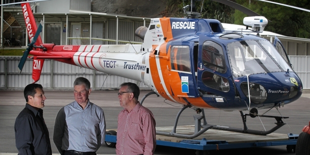 GRATEFUL: Michael Cooney (centre) seen last year with the rescue helicopter for which TrustPower and TECT had just contributed another $850,000. He was flanked by pilot Liam Brettkelly (left) and TrustPower's Graeme Purches.