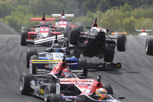 Bruno Bonifacio mounts the rear of Jann Mardenborough's car in race one at Hampton Downs. Photo / Bruce Jenkins