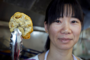 Lidong Xu displays a deep-fried chocolate chip cookie. Photo / Natalie Slade