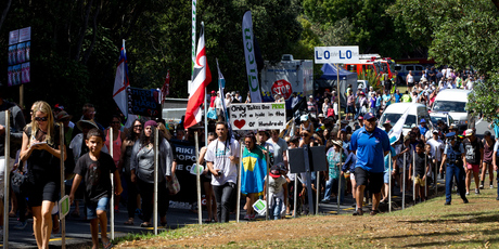 Members of the anti family violence hikoi march up the hill to the Treaty Grounds during Waitangi celebrations. Photo / Sarah Ivey
