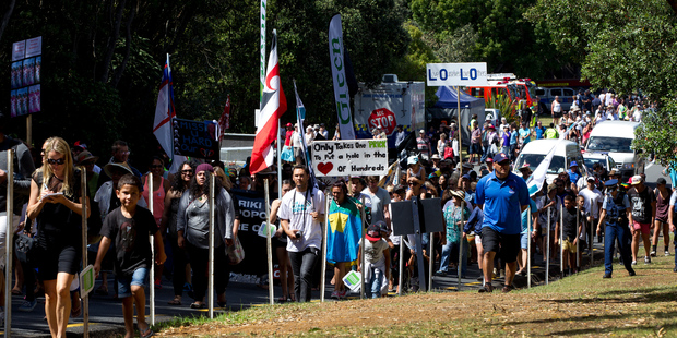 Members of the anti family violence hikoi march up the hill to the Treaty Grounds during Waitangi celebrations. Photo / Sarah Ivey