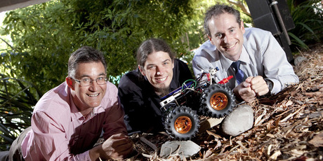 Richard Parker, Andre Geldenhuis and Chris Hann with the small UC rover robot designed to inspect floor piles of damaged buildings. Photo / Supplied