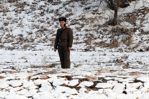 A North Korean soldier patrols along the river bank of the North Korean town of Sinuiju. Photo / AP