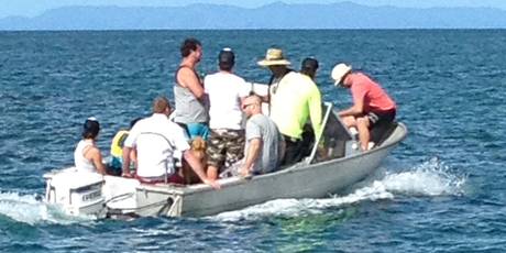 The smallest child is the only one of the nine people in the dinghy wearing a lifejacket. Photo / Gary Carruthers
