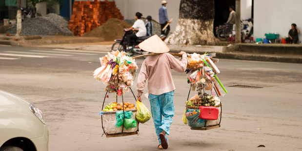 A Ho Chi Minh street vendor laden with wares. Photo / Thinkstock