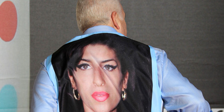 Mitchell Winehouse displays his shirt with an image of his deceased daughter Amy Winehouse. Photo / AP