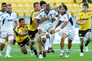 Peter Saili of the Blues is tackled by Brad Shields of the Hurricanes. Photo / Getty Images.