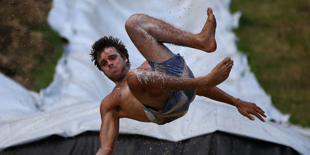 People left their worries behind to enjoy the thrills and spills on the 650m waterslide dug on farmland at Waimauku. Photo / Getty Images