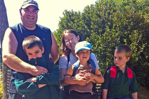The Daines family - dad Damon, mum Claire and (front, from left) Logan, Reuben and Ethan - face the closure of their neighbourhood school. Photo / Kurt Bayer