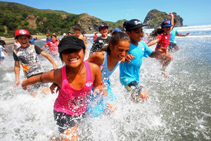 From left, Victoria Faasavalu, Chance Morgan and Sione Niupalau, all 10, enjoying the Piha surf. Photo / Chris Gorman