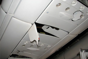 Example of damage to the fittings above passenger seats in the rear section of the Qantas Airbus 330. Photo / Supplied by ATSB
