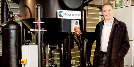 Nick Gerritsen with the firm's industrial microwave, which can turn waste sawdust into valuable carbon products. Photo / Gill South