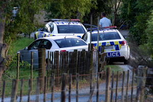 Police at the Kaipara Flats scene last night. Photo / Natalie Slade