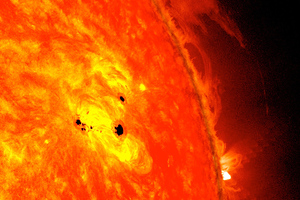 The bottom two black spots on the sun, known as sunspots, appeared quickly over the course of February 19-20, 2013. Image / NASA/SDO/Goddard Scientific Visualization Studio