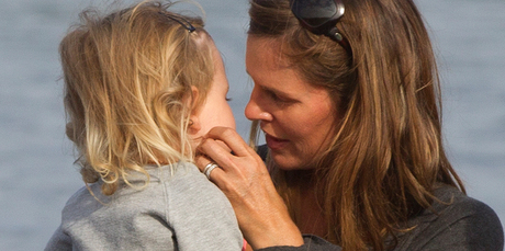 Meg Strange, the wife of shark victim Adam Strange, with daughter Indigo, 2, at Muriwai Beach. Photo / Brett Phibbs