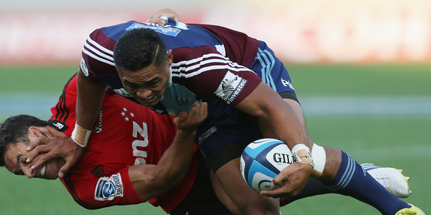 Francis Saili of the Blues fends off Daniel Carter of the Crusaders. Photo / Getty Images.